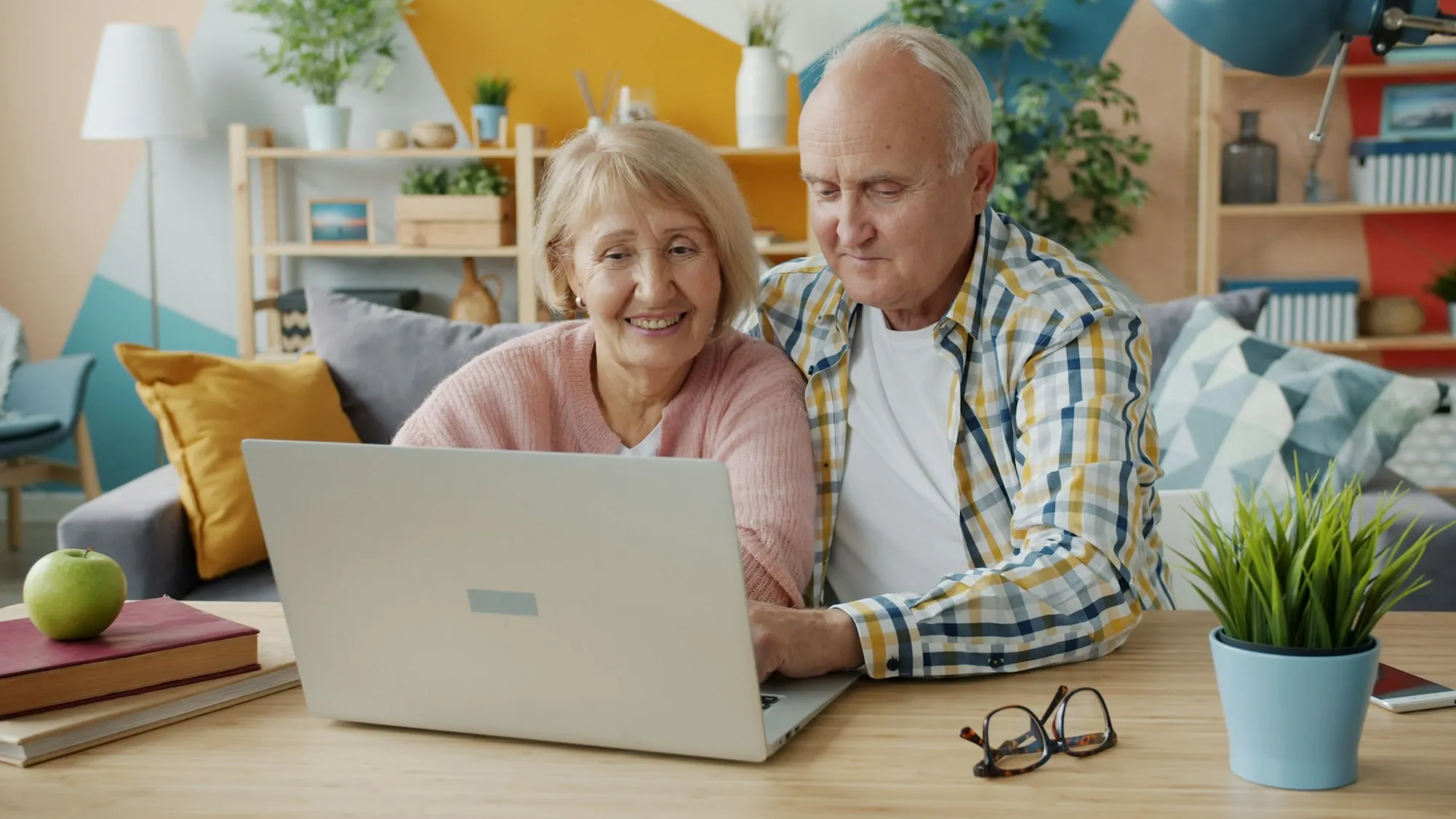 Older couple reviewing information together on a laptop