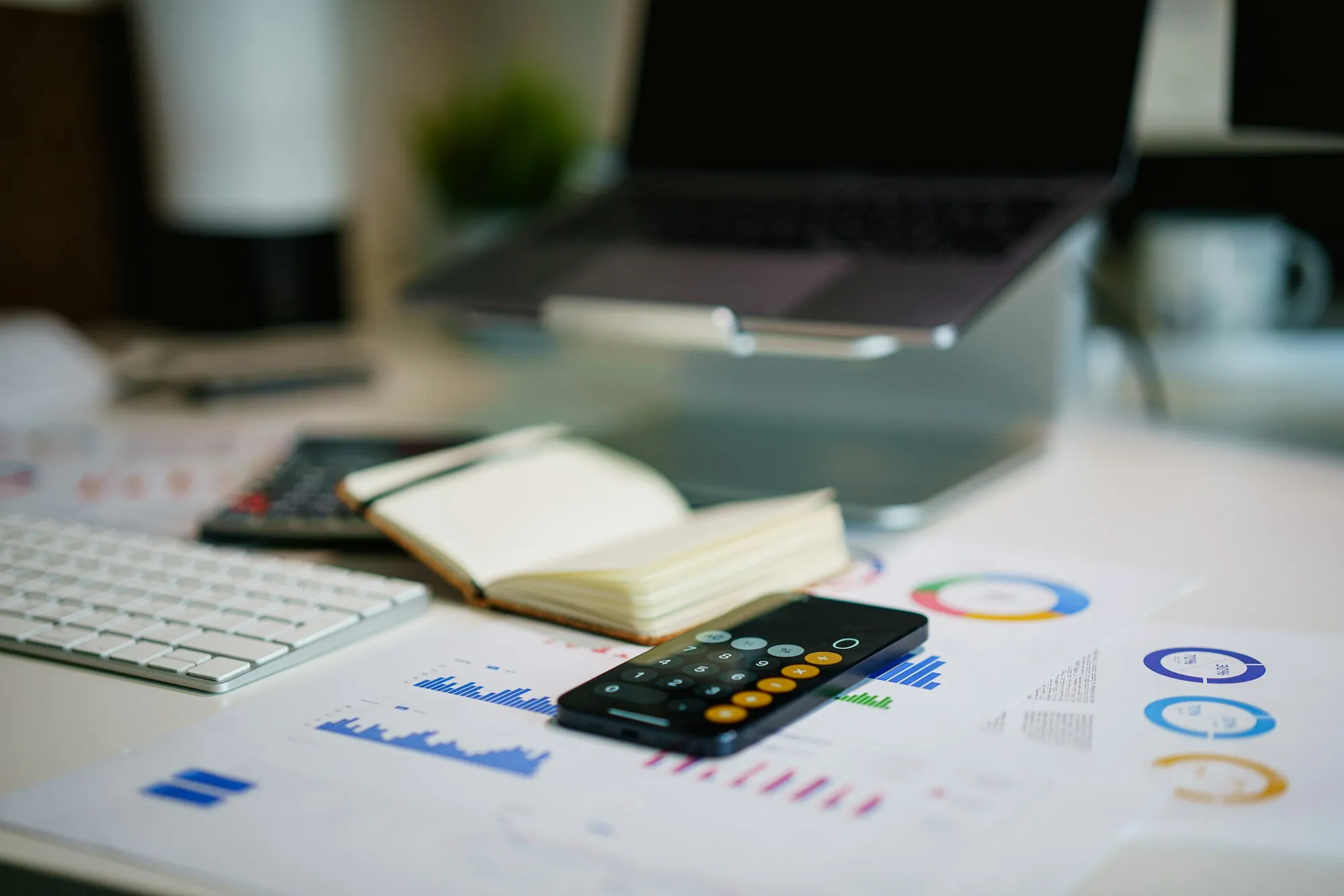 Charts, a calculator and a notebook on a desk